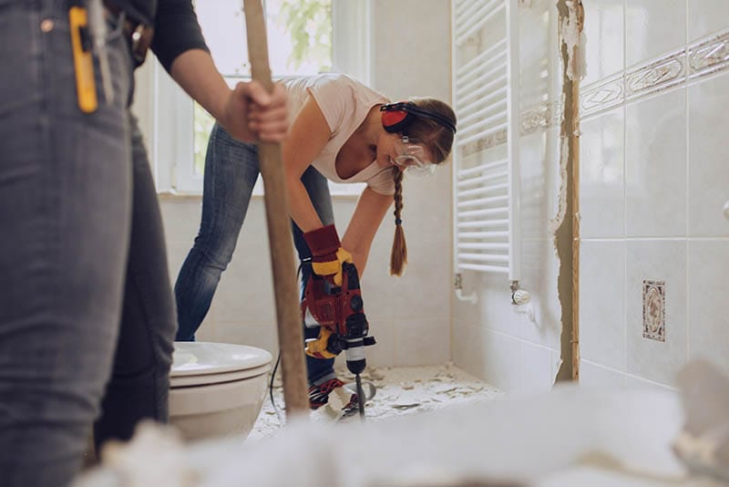 Woman works on remodeling her bathroom